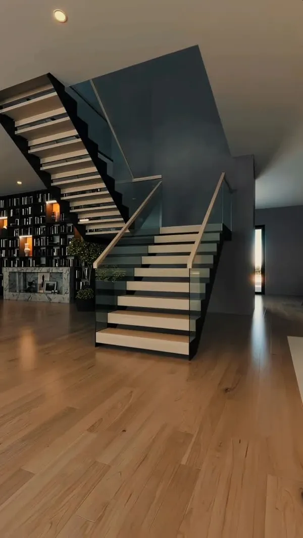 Frameless glass balustrade railing on a floating stair in a NYC interior
